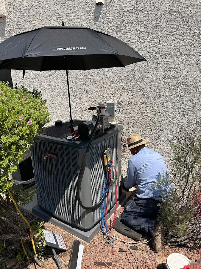 HVAC technician performing outdoor AC maintenance in Bainbridge Island